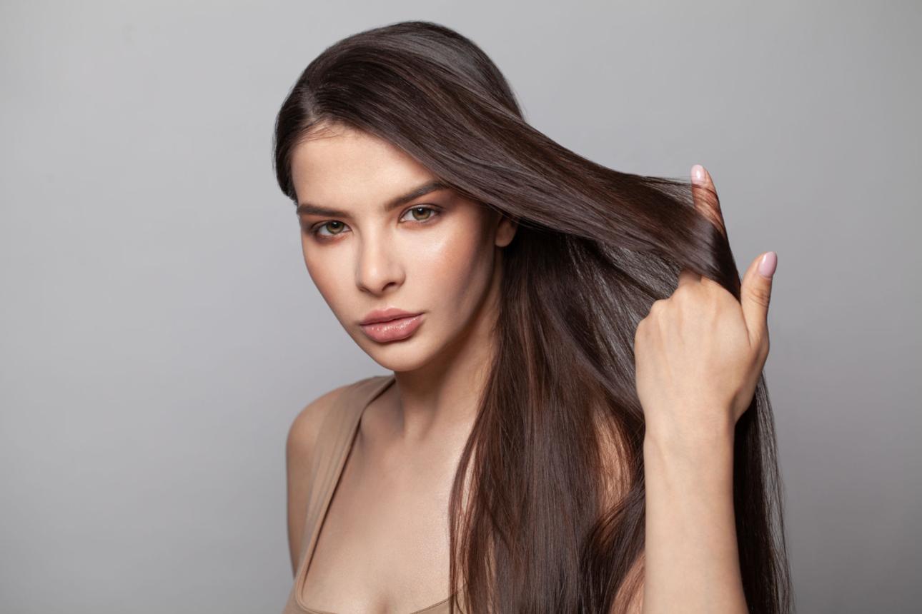 Beautiful woman with shiny healthy hair after a collagen and keratin hair care routine