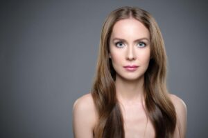 Woman with smooth glowing hair using a collagen and keratin hair mask