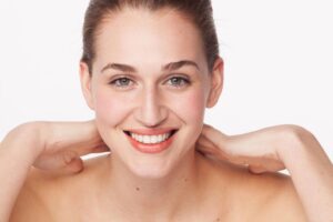 Woman with smooth glowing skin using collagen anti aging skincare