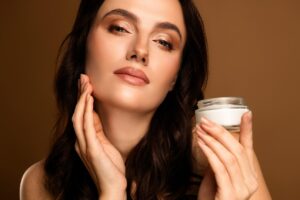 Woman applying hydrating skincare cream for glowing healthy-looking skin