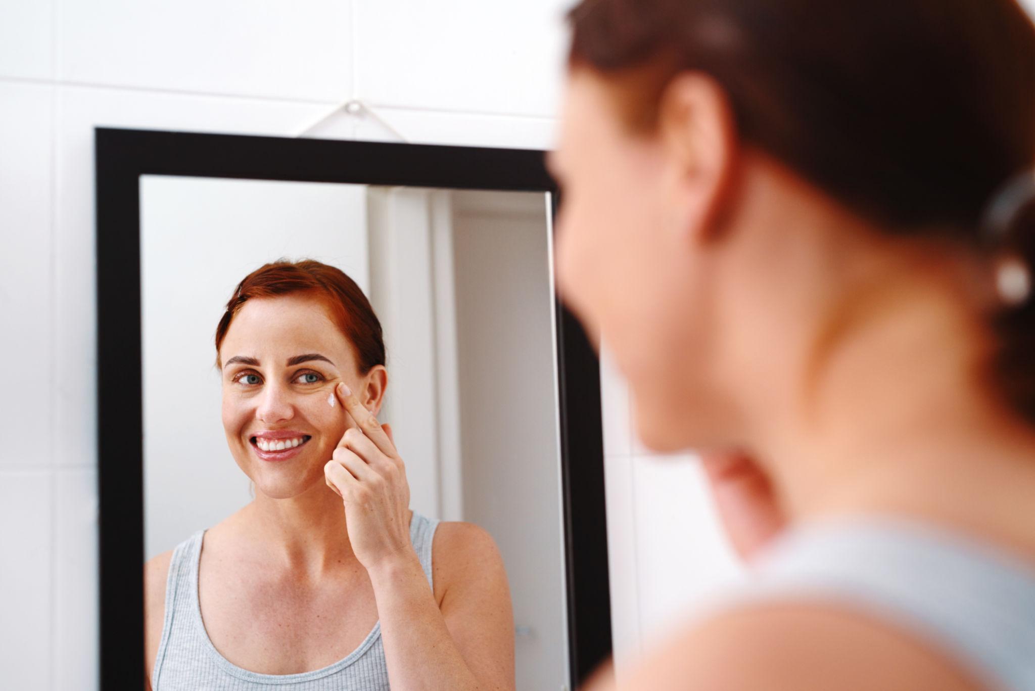 Woman with hydrated glowing skin using collagen serum skincare